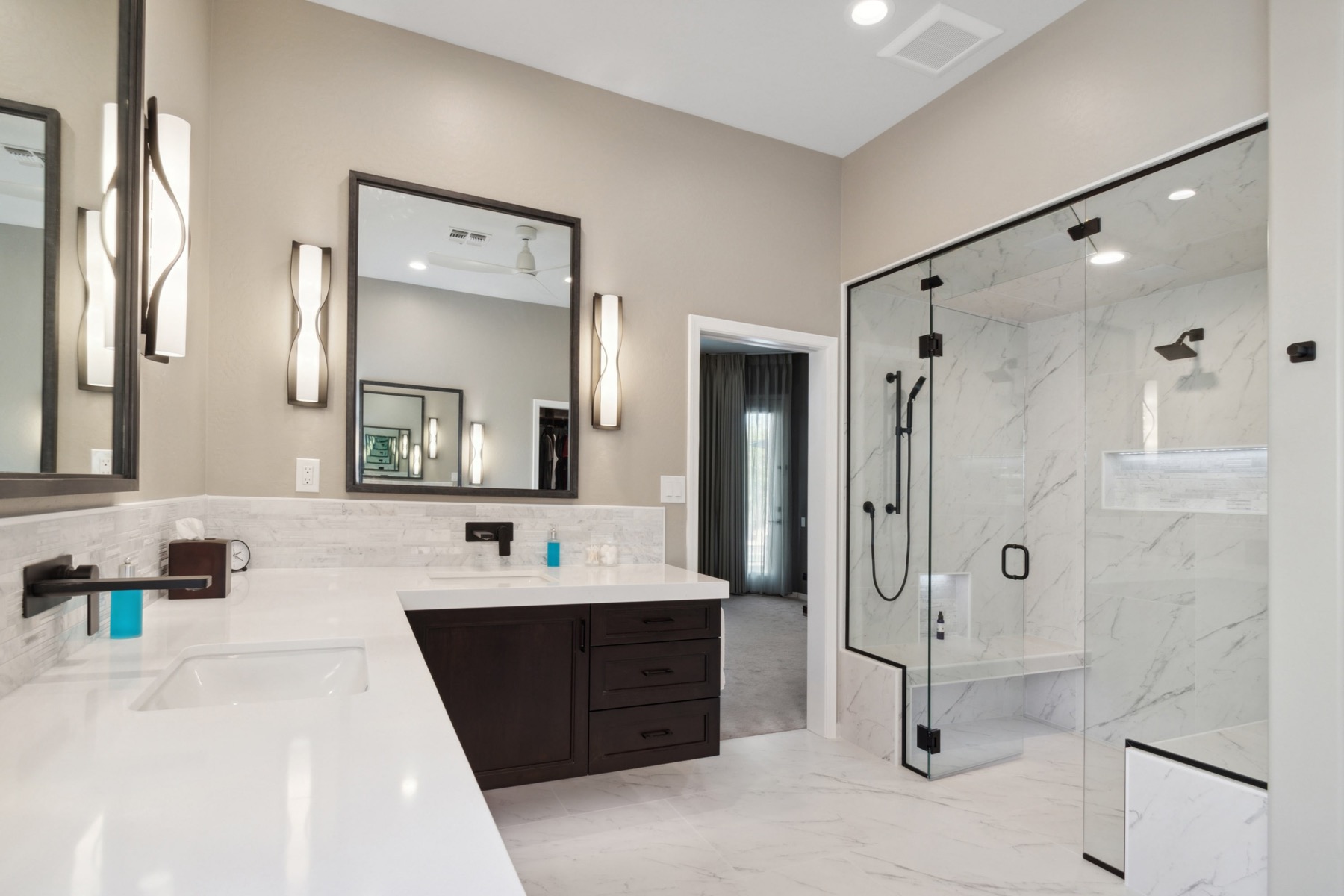 Primary bathroom remodel with walk-in glass shower and marble tile