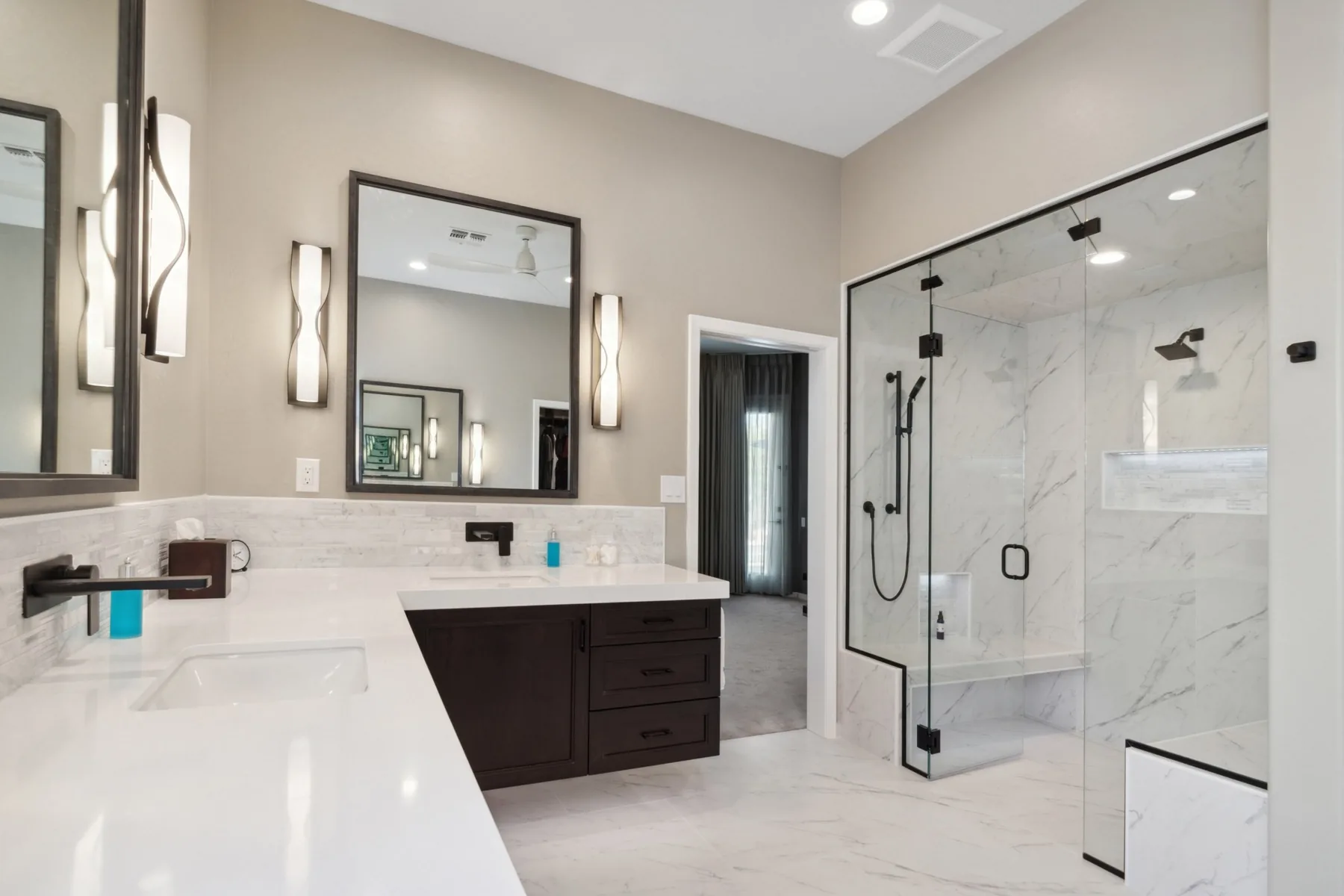 Primary bathroom remodel with walk-in glass shower and marble tile